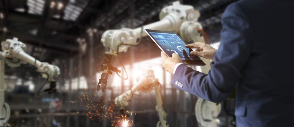 Manager industrial engineer using tablet check and control autom